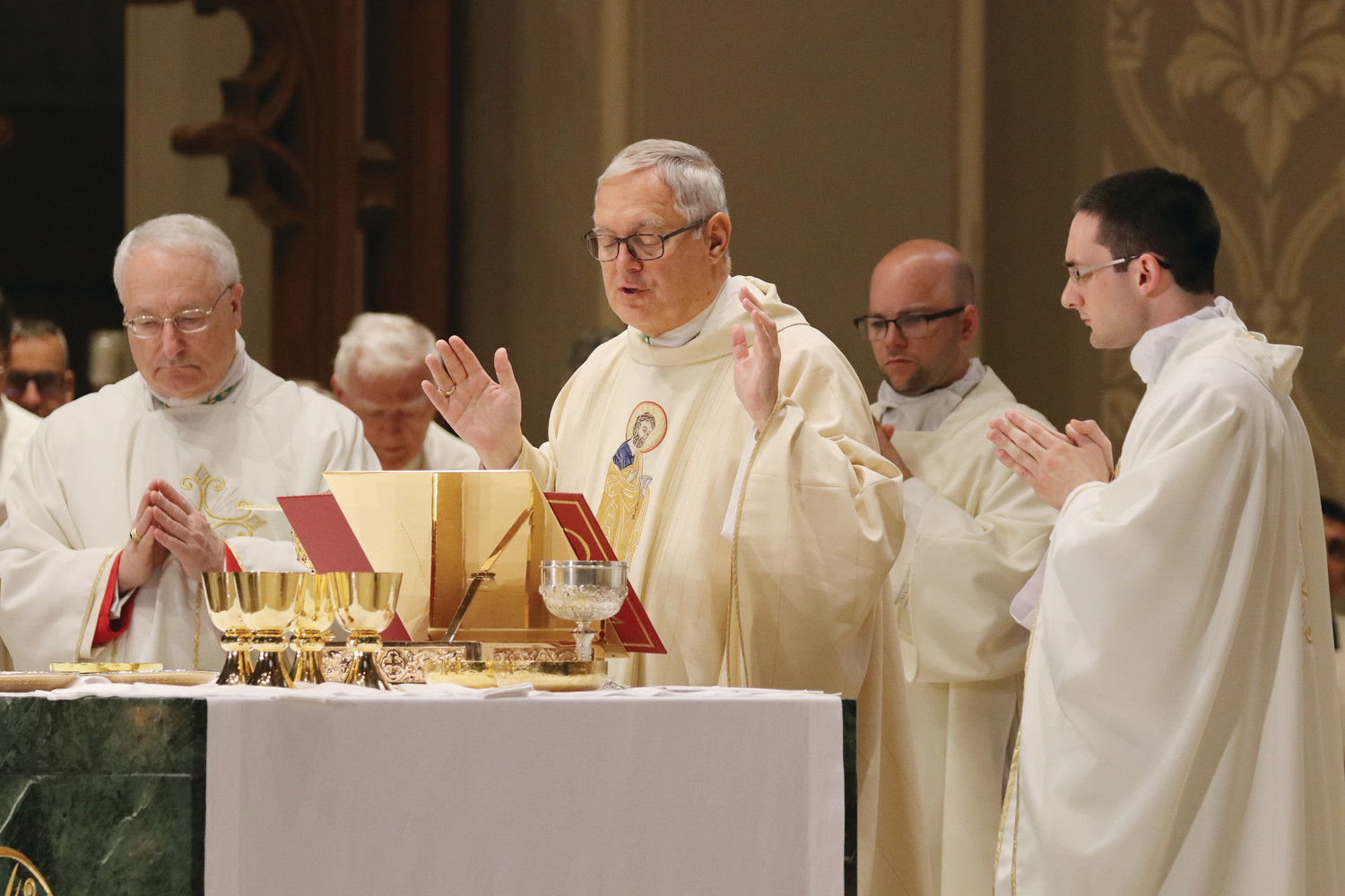 Father Dufour joins Bishop Tobin, center, and Auxiliary Bishop Robert C. Evans at the altar.